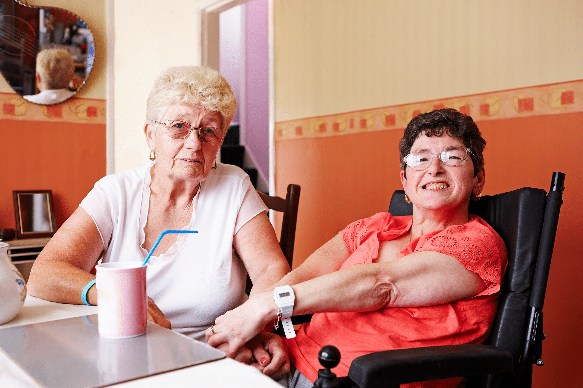 Portrait of disabled woman with her mother at home